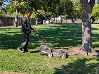 student mowing the lawn
