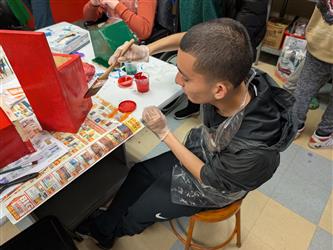 student and staff playing UNO